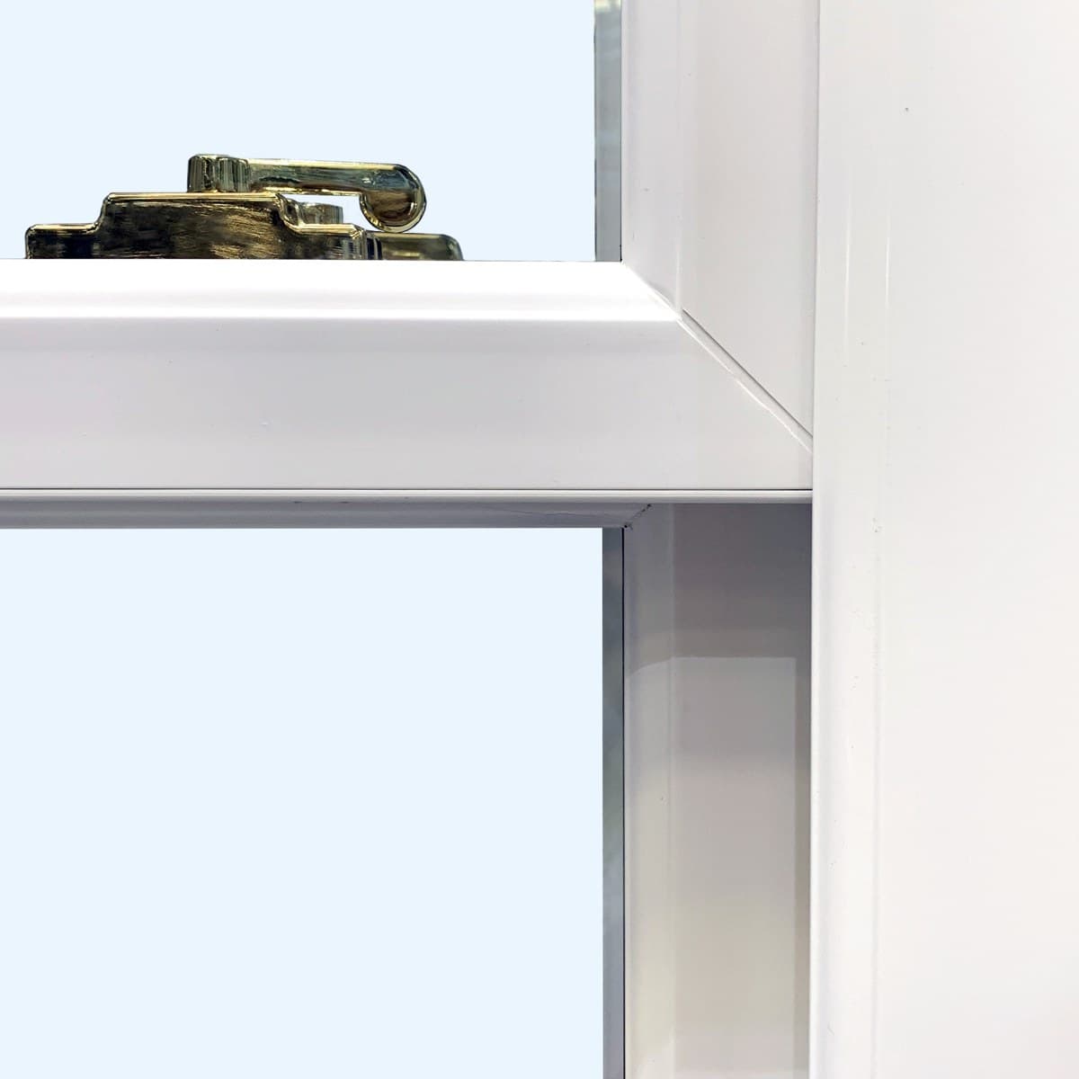 Brass high-security cam lock on the meeting rail of a sliding sash window